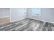 Comfortable bedroom with plank floors, light blue walls, and a view to the ocean at 3180 Ocean Shore Blvd # 309, Ormond Beach, FL 32176