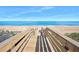 A wooden boardwalk leading to the sandy beach and ocean at 3180 Ocean Shore Blvd # 309, Ormond Beach, FL 32176