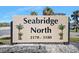 Seabridge North community sign in a landscaped area with palm trees on a sunny day at 3180 Ocean Shore Blvd # 309, Ormond Beach, FL 32176