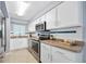 Bright kitchen with stainless steel appliances and white cabinets, plenty of room for cooking and storage at 3180 Ocean Shore Blvd # 309, Ormond Beach, FL 32176