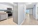 Bright kitchen with stainless steel appliances and white cabinets, complemented by ceramic tile floors at 3180 Ocean Shore Blvd # 309, Ormond Beach, FL 32176