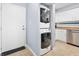 Convenient in-unit laundry featuring a stacked washer and dryer, adjacent to the kitchen area at 3180 Ocean Shore Blvd # 309, Ormond Beach, FL 32176