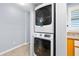 In-unit laundry with stackable washer and dryer near sink area at 3180 Ocean Shore Blvd # 309, Ormond Beach, FL 32176