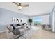 Bright living room with a ceiling fan, modern furniture, and a sliding glass door with ocean views at 3180 Ocean Shore Blvd # 309, Ormond Beach, FL 32176