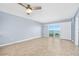 Bright, airy living room featuring a ceiling fan, tiled floors and access to a balcony with beautiful views at 3180 Ocean Shore Blvd # 309, Ormond Beach, FL 32176