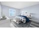 Bedroom with a large bed, light blue walls, and a window with blinds looking out to the ocean at 3180 Ocean Shore Blvd # 309, Ormond Beach, FL 32176