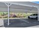 View of covered parking, with a vehicle parked in the space at 3180 Ocean Shore Blvd # 309, Ormond Beach, FL 32176
