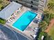 Aerial view of rectangular community pool with poolside furniture and lounge chairs at 3180 Ocean Shore Blvd # 309, Ormond Beach, FL 32176