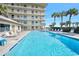 View of the blue swimming pool with lounge chairs at 3180 Ocean Shore Blvd # 309, Ormond Beach, FL 32176