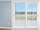 Window with plantation shutters offers stunning ocean views, natural light, and enhanced privacy at 3180 Ocean Shore Blvd # 309, Ormond Beach, FL 32176