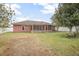 Large backyard featuring a screened in porch and vinyl fence that offers privacy to the home at 35909 Joewood Ave, Leesburg, FL 34788
