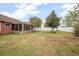 Large backyard featuring a screened patio and white fence at 35909 Joewood Ave, Leesburg, FL 34788