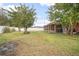 Large backyard featuring a screened patio and white fence at 35909 Joewood Ave, Leesburg, FL 34788