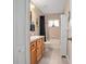 Bright bathroom featuring a shower/tub combo, vanity with wooden cabinets, and storage cabinet at 35909 Joewood Ave, Leesburg, FL 34788