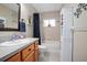 Bright bathroom featuring a shower/tub combo, vanity with wooden cabinets, and storage cabinet at 35909 Joewood Ave, Leesburg, FL 34788