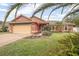Charming single-story home with a well-maintained lawn and a two-car garage at 35909 Joewood Ave, Leesburg, FL 34788