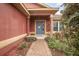 Inviting front entrance with landscaped garden leading up to a blue front door at 35909 Joewood Ave, Leesburg, FL 34788