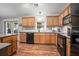 Well-equipped kitchen with wood cabinets, modern appliances, and a stylish backsplash at 35909 Joewood Ave, Leesburg, FL 34788