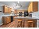 Spacious kitchen featuring wood cabinets, updated appliances, and a breakfast bar at 35909 Joewood Ave, Leesburg, FL 34788