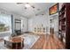 Bright living room with hardwood floors, stylish furniture, and arched doorways at 35909 Joewood Ave, Leesburg, FL 34788