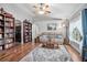 Cozy living room with hardwood floors, comfortable seating, and decorative shelving at 35909 Joewood Ave, Leesburg, FL 34788