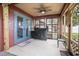 Covered screened patio with ceiling fan, grill, and dining table at 35909 Joewood Ave, Leesburg, FL 34788