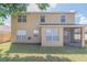 Back exterior of home with screened lanai, tan color, and fenced yard at 3633 Sickle St, Orlando, FL 32812