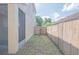 Narrow backyard area featuring a wooden fence and minimal landscaping at 3633 Sickle St, Orlando, FL 32812