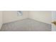 Neutral-toned bedroom with carpet, bright window and a door with a gold handle at 3633 Sickle St, Orlando, FL 32812