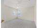Cozy bedroom with two windows, carpet, ceiling fan, and a door at 3633 Sickle St, Orlando, FL 32812