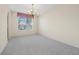 Spacious dining room with natural light, neutral carpet, and classic chandelier at 3633 Sickle St, Orlando, FL 32812