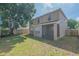 Rear exterior view of the home featuring a screened-in patio and spacious backyard at 3633 Sickle St, Orlando, FL 32812