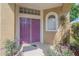 Close-up of front door entry with detailed door, potted plants, and ample natural light at 3633 Sickle St, Orlando, FL 32812