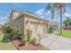 Exterior shot of a two-car garage featuring a neutral color and a well-kept driveway at 3633 Sickle St, Orlando, FL 32812