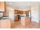 Bright kitchen features tile floors, stainless steel appliances, wooden cabinetry, and kitchen island at 3633 Sickle St, Orlando, FL 32812