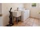 Functional laundry room with washer, dryer, utility sink, and storage shelf at 3633 Sickle St, Orlando, FL 32812