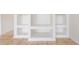 A built-in shelving unit offers ample storage and style to this bright and airy living room at 3633 Sickle St, Orlando, FL 32812