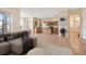 Open-concept kitchen and living area with tiled flooring, wooden cabinets, stainless appliances, and modern furniture at 3633 Sickle St, Orlando, FL 32812