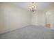 Bright living area with neutral carpet, recessed lighting, and arched doorway at 3633 Sickle St, Orlando, FL 32812