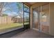 Comfortable screened patio with views of a grassy backyard and a secure wooden fence, perfect for relaxation and privacy at 3633 Sickle St, Orlando, FL 32812