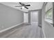 Bedroom with ample space, light gray walls, wood-look floors, closet space, and natural light at 387 Paradise Dr, Deland, FL 32720