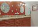 Double vanity bathroom with granite countertops and decorative accents at 4 Oceans West Blvd # 502D, Daytona Beach Shores, FL 32118