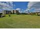 Landscaped golf course with condo building in the background at 4 Oceans West Blvd # 502D, Daytona Beach Shores, FL 32118