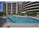Resort-style pool with surrounding lounge chairs and building view at 4 Oceans West Blvd # 502D, Daytona Beach Shores, FL 32118
