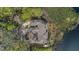 Aerial view of home on the water with a well-manicured lot and mature landscaping at 510 Sandy Bluff Trl, Deland, FL 32724