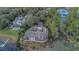 Lakefront home with a large yard, dock, and spacious backyard featuring a screened-in porch at 510 Sandy Bluff Trl, Deland, FL 32724