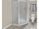 Bathroom with a glass enclosed shower, toilet, and a window with pink trim at 510 Sandy Bluff Trl, Deland, FL 32724