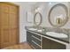 Bathroom featuring double sinks, decorative mirrors, and a tiled backsplash at 510 Sandy Bluff Trl, Deland, FL 32724