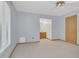 Spacious bedroom with neutral carpet and light blue walls and access to bathroom at 510 Sandy Bluff Trl, Deland, FL 32724
