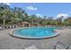 Community swimming pool with lounge chairs and clear blue sky at 510 Sandy Bluff Trl, Deland, FL 32724